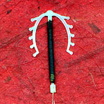 Contraceptive coil on a red background