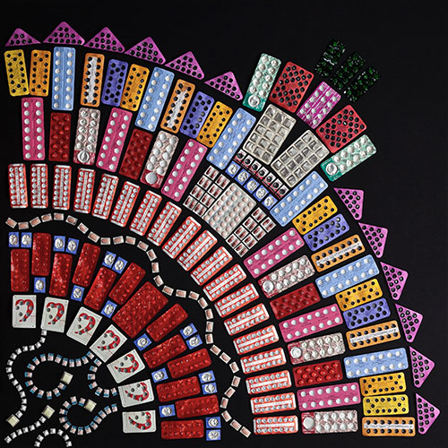 Colourful pill packets arranged to look like a flower